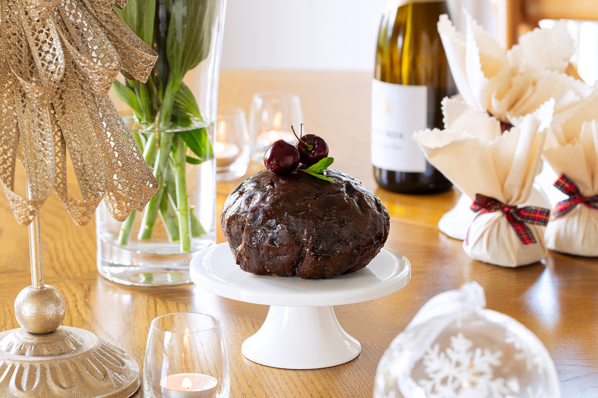 Whole Christmas pudding on a cake stand